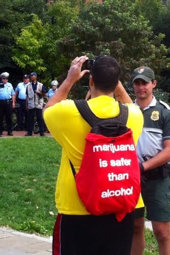 4/20 marijuana legalization protester photographs police on the lookout for drug users at Philadelphia's Liberty Bell protest